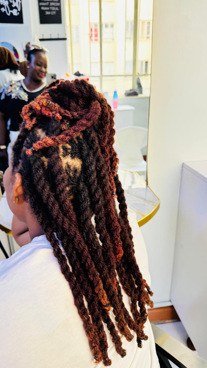 Sisterlocks arranged into a finished highlighted updo
